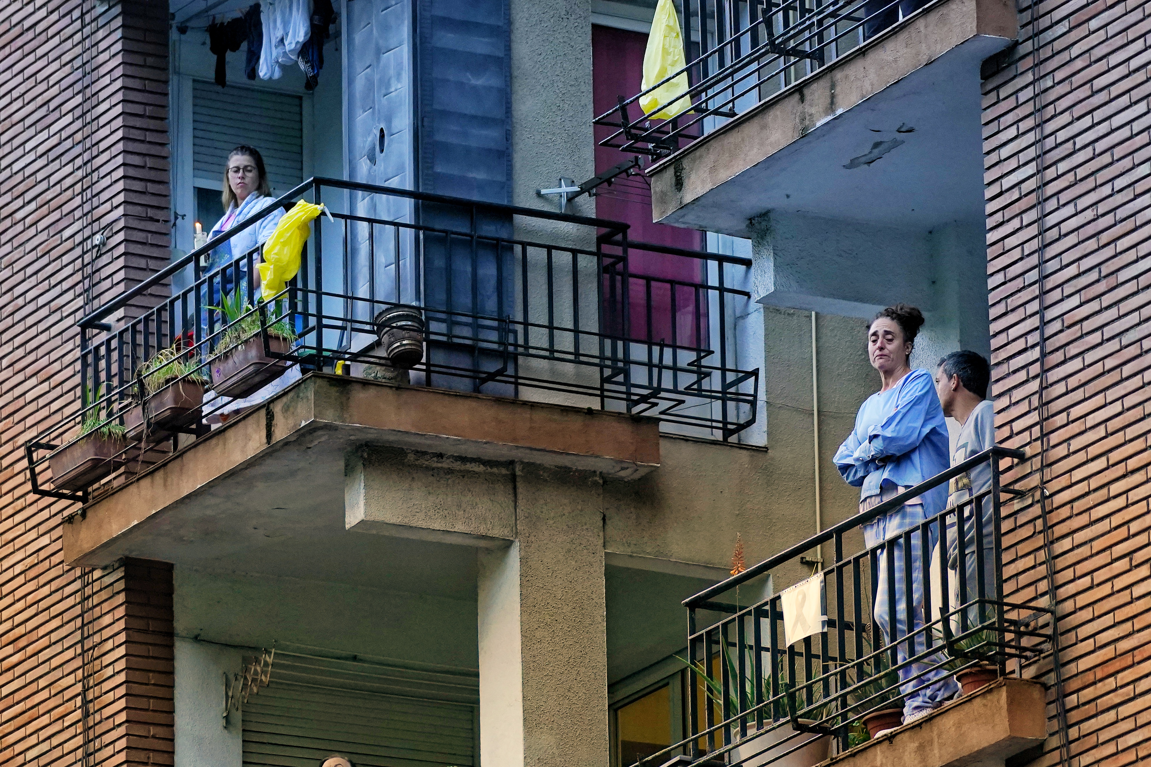 Neighbors on their windows and balconies watching the hologram